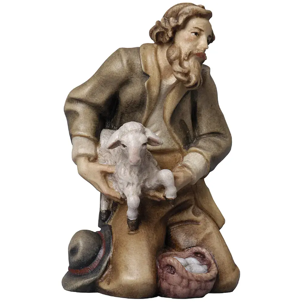 Hirte kniend mit Schaf